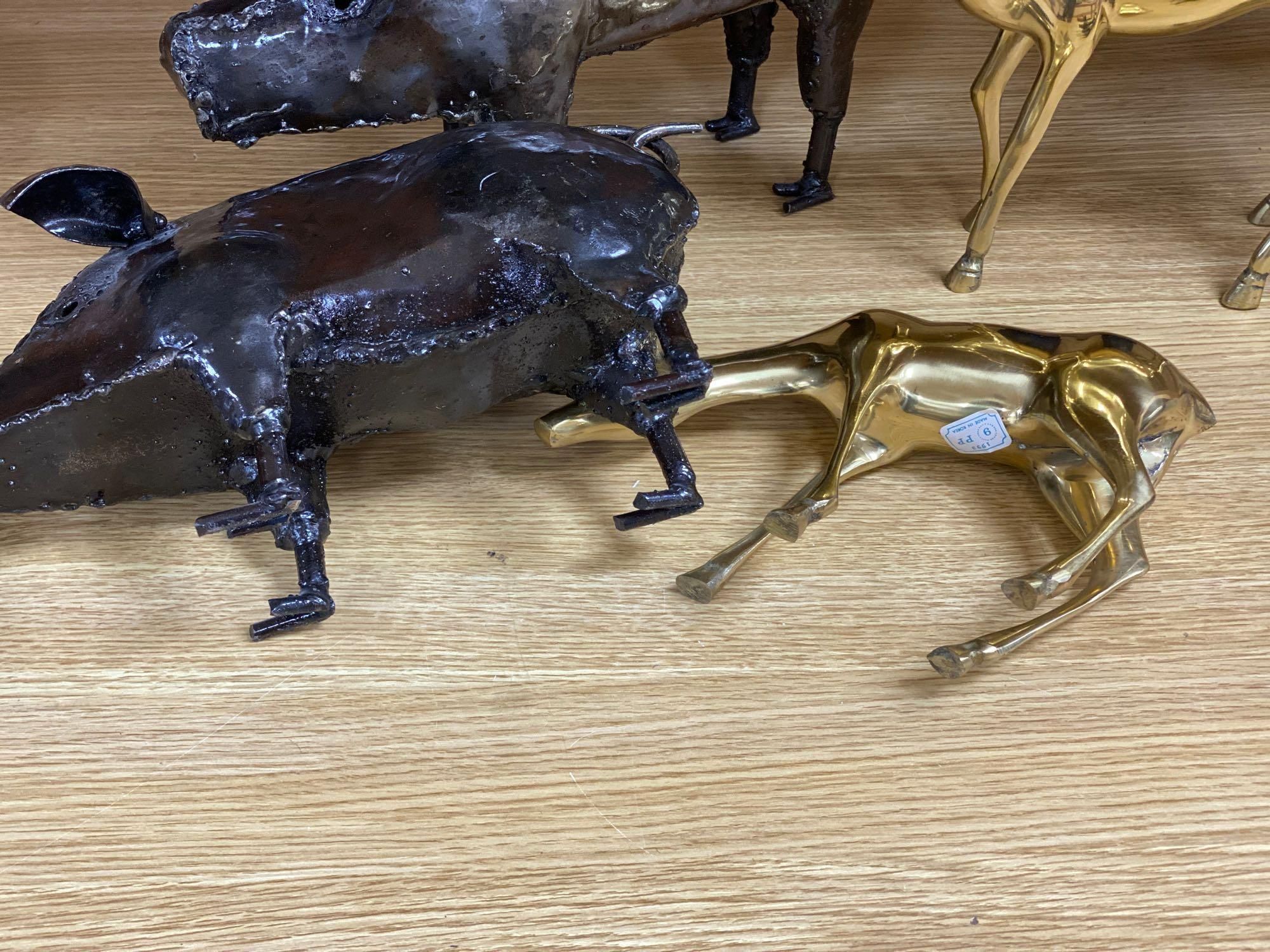 A pair of wrought iron models of pigs